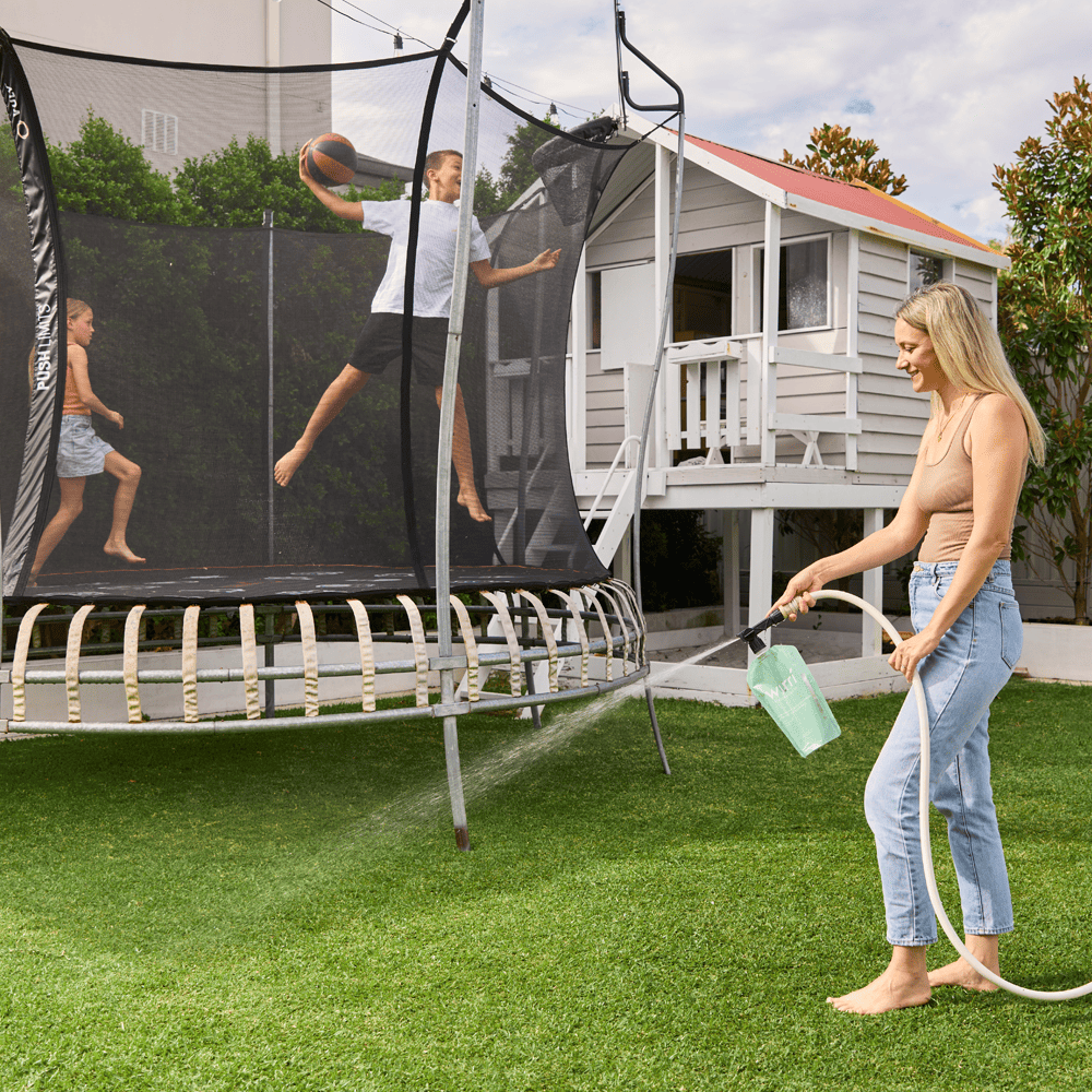 Sustainable gardening solutions - Woman using lawn products