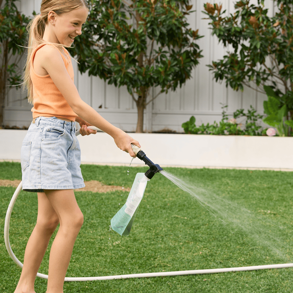 Australian Lawn Care - girl using lawn care product