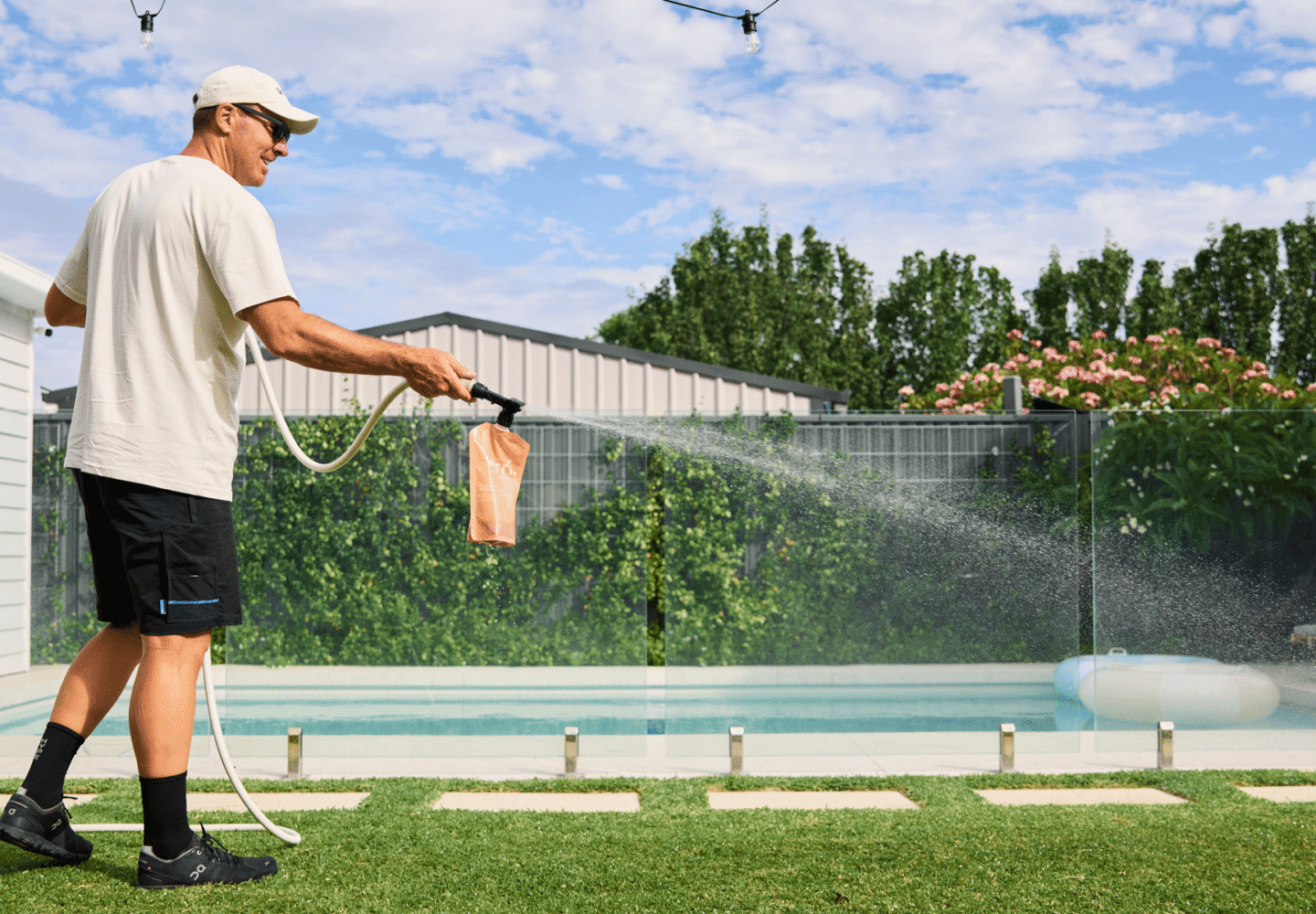 Organic Lawn Care - Man using lawn care product