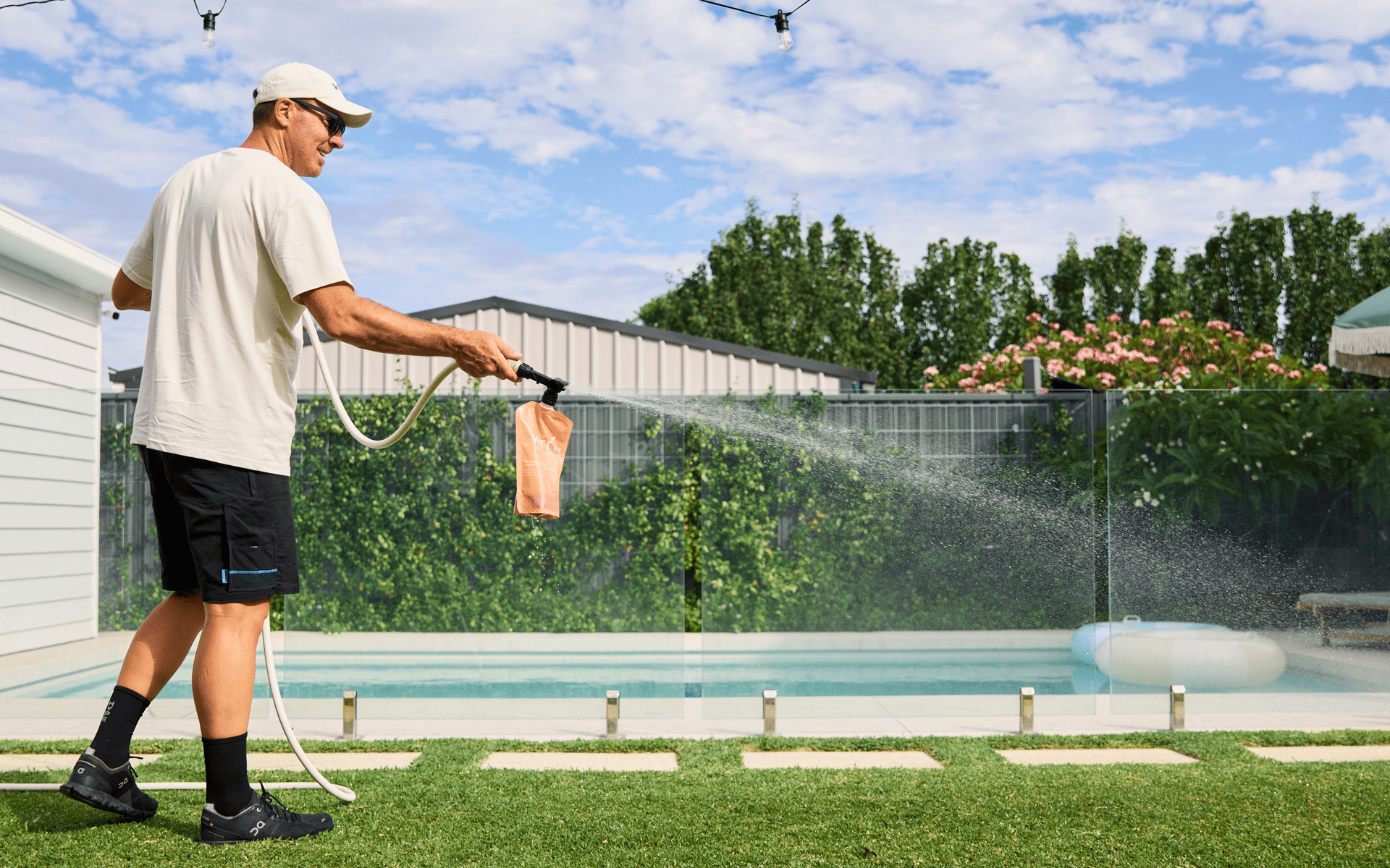 Organic Lawn Care - Man using lawn care product